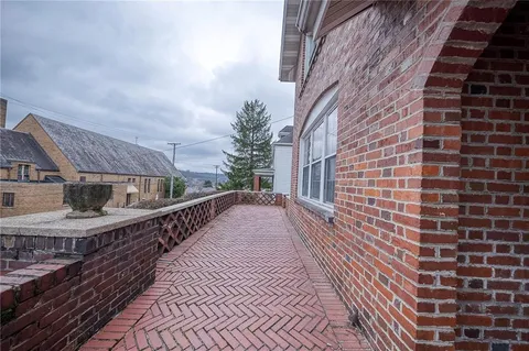 a view of a brick house with a large windows