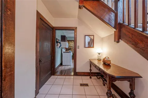 a view of a hallway with workspace and a window
