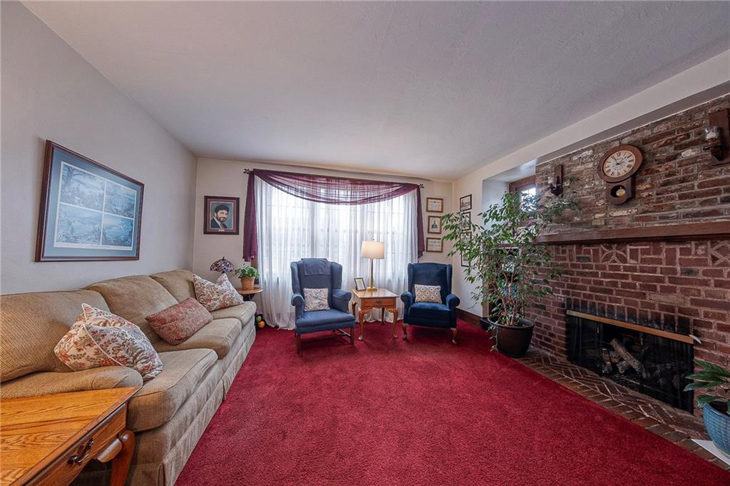 451 Walnut Street Pittsburgh, PA 15238 - Photo 7 of 40 a living room with furniture a fireplace and a flat screen tv