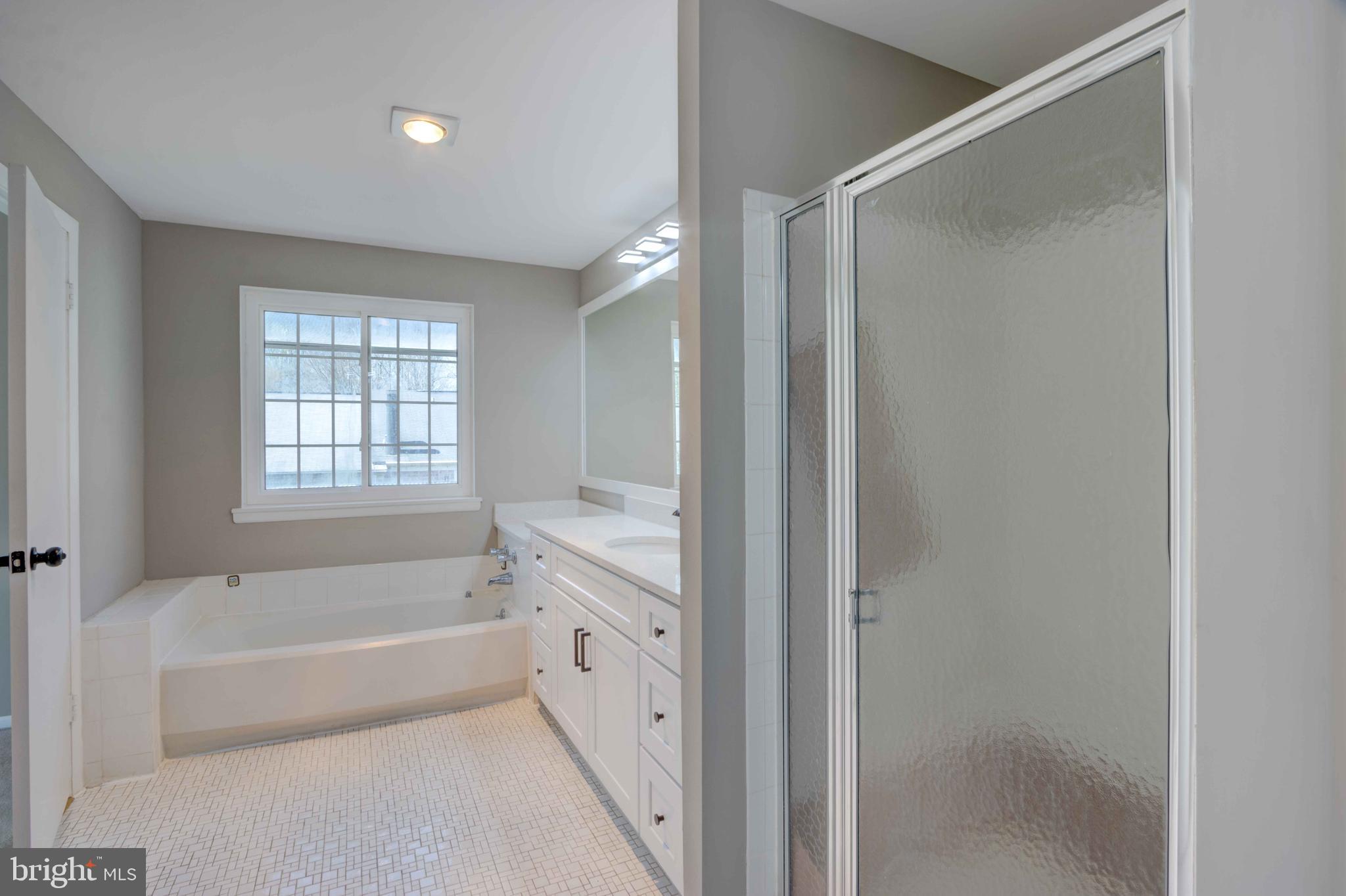 11859 Blue February Way Columbia, MD 21044 - Photo 17 of 35 a bathroom with a bathtub and a shower