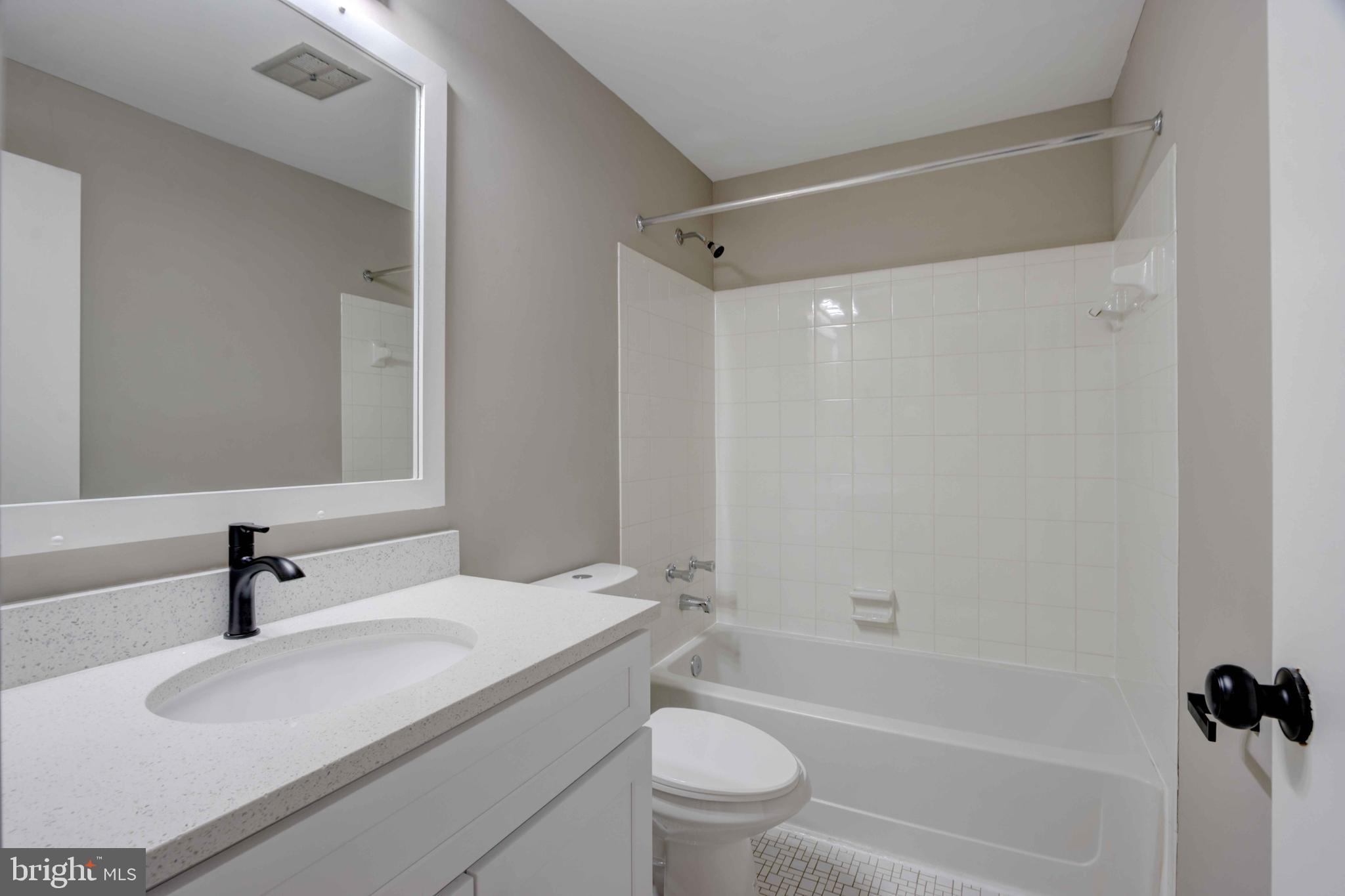 11859 Blue February Way Columbia, MD 21044 - Photo 20 of 35 a bathroom with a granite countertop sink a toilet and shower