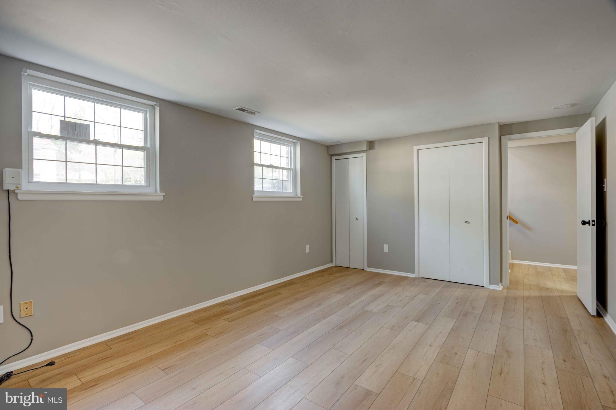 11859 Blue February Way Columbia, MD 21044 - Photo 25 of 35 a view of an empty room with wooden floor and a window