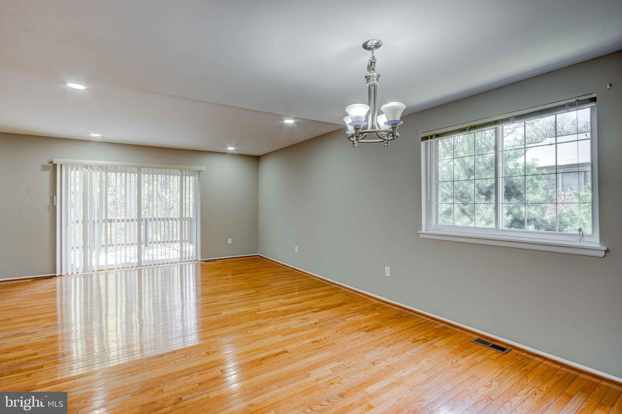 11859 Blue February Way Columbia, MD 21044 - Photo 3 of 35 a view of an empty room with wooden floor and a window