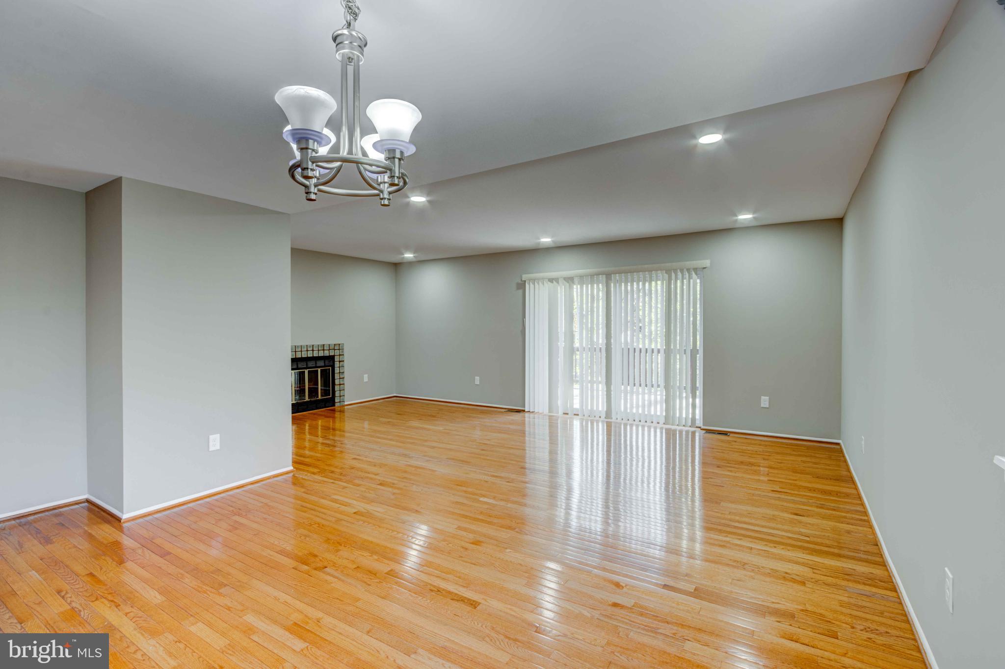 11859 Blue February Way Columbia, MD 21044 - Photo 5 of 35 a view of an empty room with wooden floor