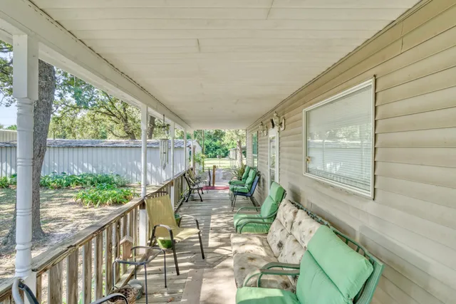 a balcony view with a large window and furniture