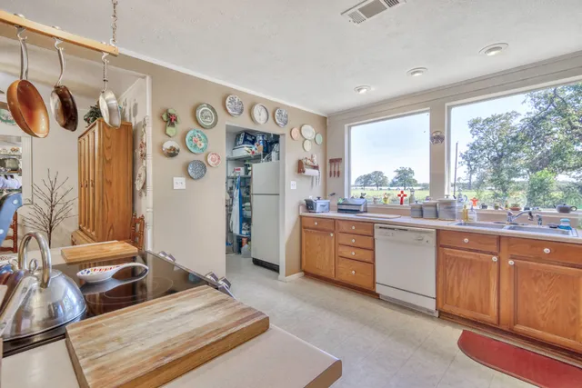 a living room with stainless steel appliances granite countertop furniture and a window