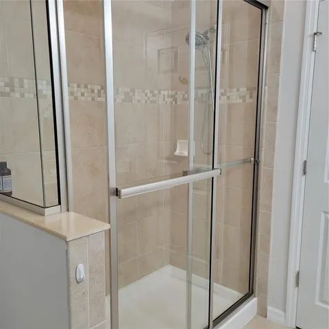 a bathroom with a glass shower door