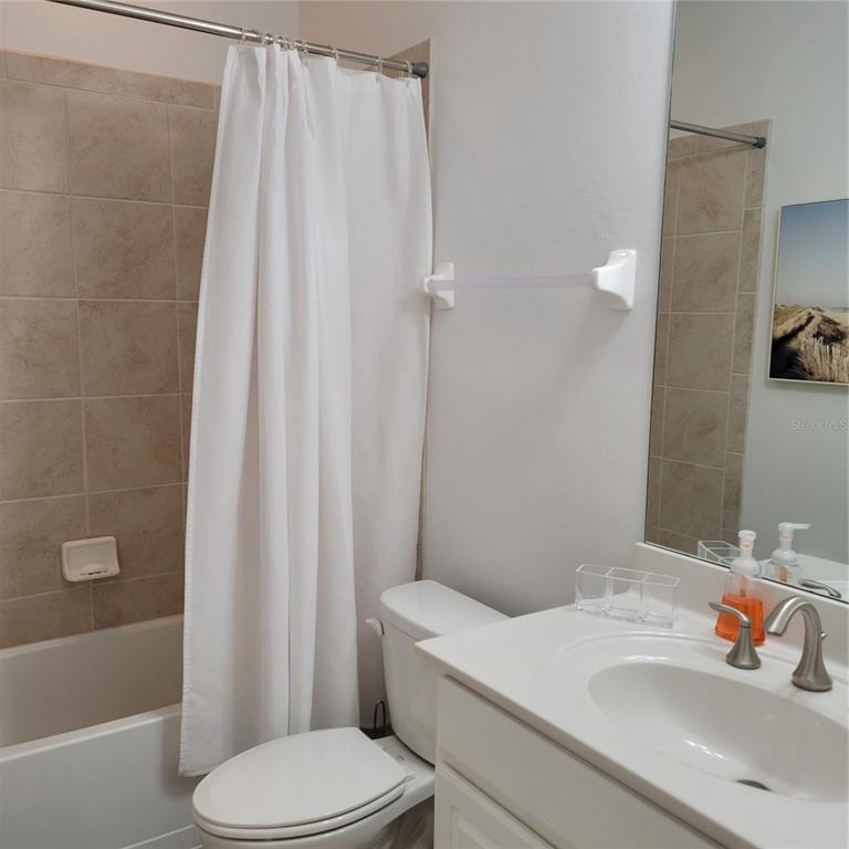 152 Navigation Circle, Unit 107 Osprey, FL 34229 - Photo 15 of 25 a bathroom with a sink toilet and shower