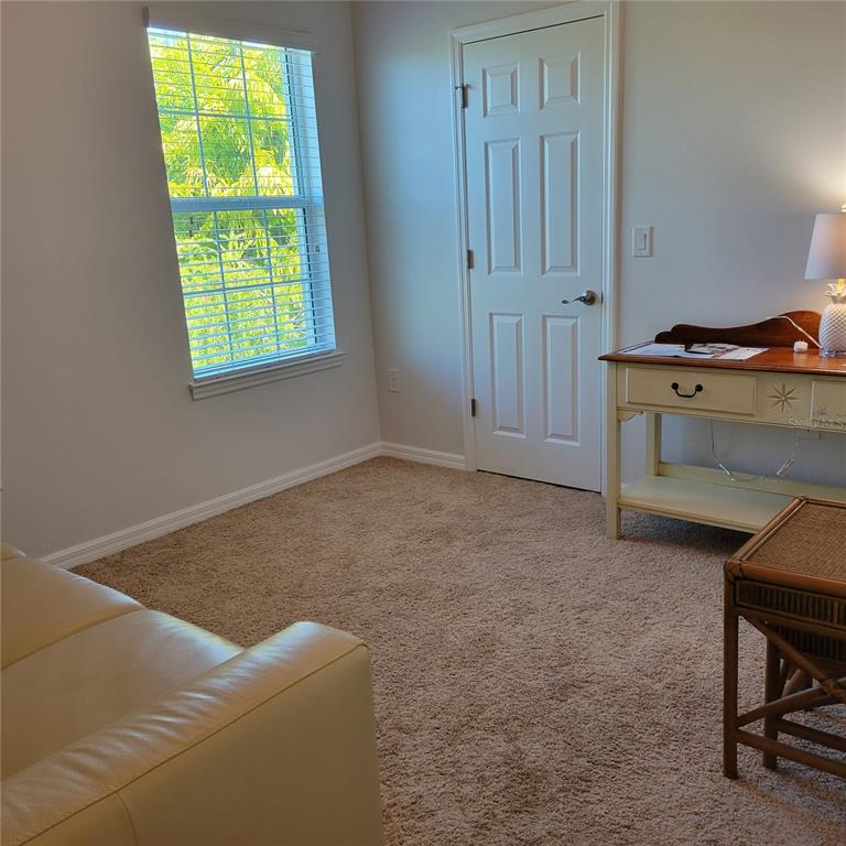 152 Navigation Circle, Unit 107 Osprey, FL 34229 - Photo 16 of 25 a room with a bed and a window