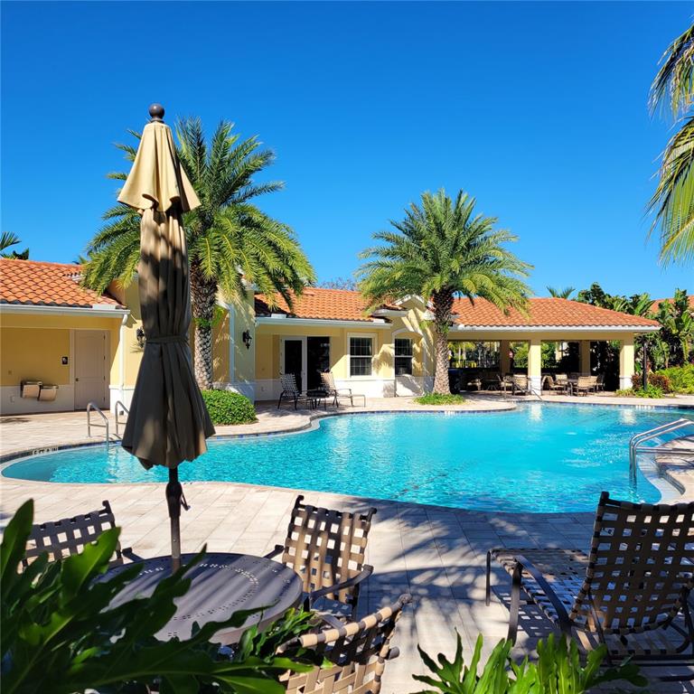 152 Navigation Circle, Unit 107 Osprey, FL 34229 - Photo 19 of 25 a front view of a house with garden