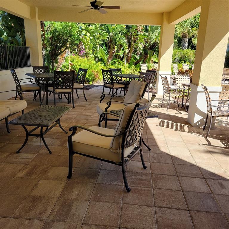 152 Navigation Circle, Unit 107 Osprey, FL 34229 - Photo 22 of 25 a view of a tables and chairs in patio