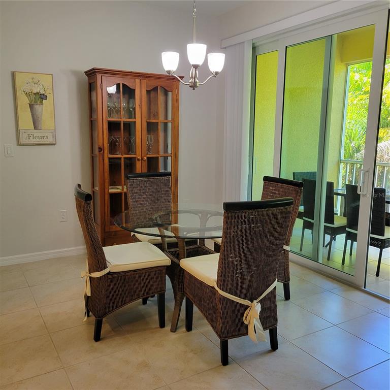 152 Navigation Circle, Unit 107 Osprey, FL 34229 - Photo 5 of 25 a view of a dining room with furniture and chandelier