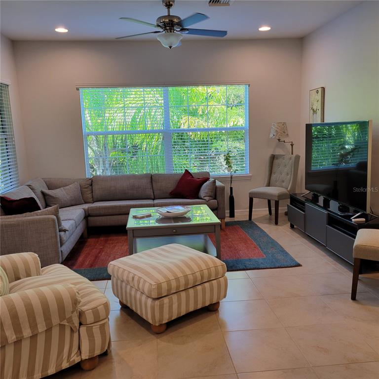 152 Navigation Circle, Unit 107 Osprey, FL 34229 - Photo 9 of 25 a living room with furniture and a flat screen tv