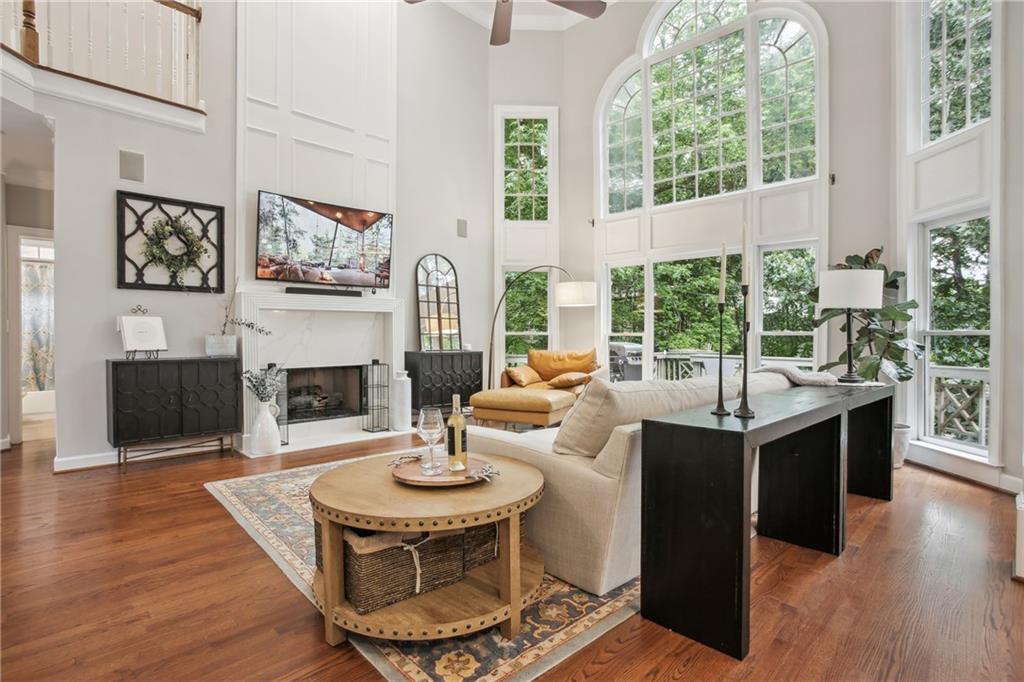 12480 Magnolia Circle Alpharetta, GA 30005 - Photo 11 of 19 a living room with furniture a fireplace and a large window