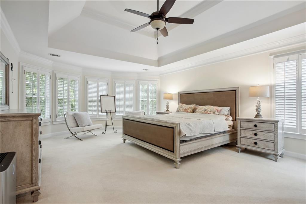 12480 Magnolia Circle Alpharetta, GA 30005 - Photo 13 of 19 a bedroom with a bed a chandelier and large window