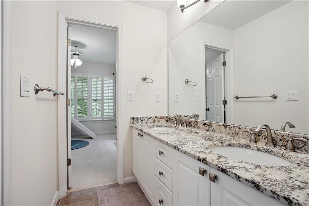 12480 Magnolia Circle Alpharetta, GA 30005 - Photo 16 of 19 a bathroom with a granite countertop sink double and mirror
