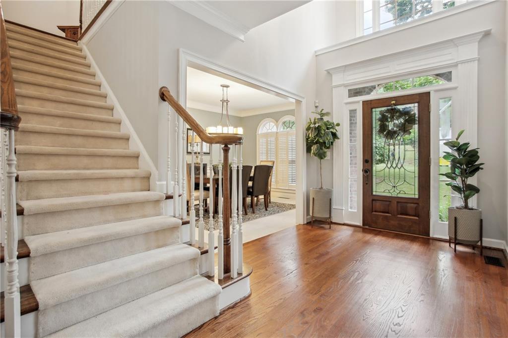 12480 Magnolia Circle Alpharetta, GA 30005 - Photo 3 of 19 a view of an entryway with wooden floor and front door