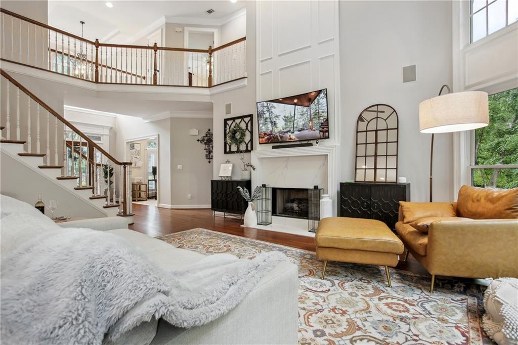 12480 Magnolia Circle Alpharetta, GA 30005 - Photo 4 of 19 a living room with furniture a fireplace and a flat screen tv
