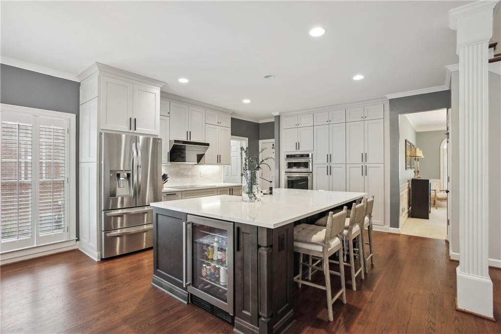 12480 Magnolia Circle Alpharetta, GA 30005 - Photo 9 of 19 a kitchen with stainless steel appliances kitchen island granite countertop a refrigerator and a stove top oven