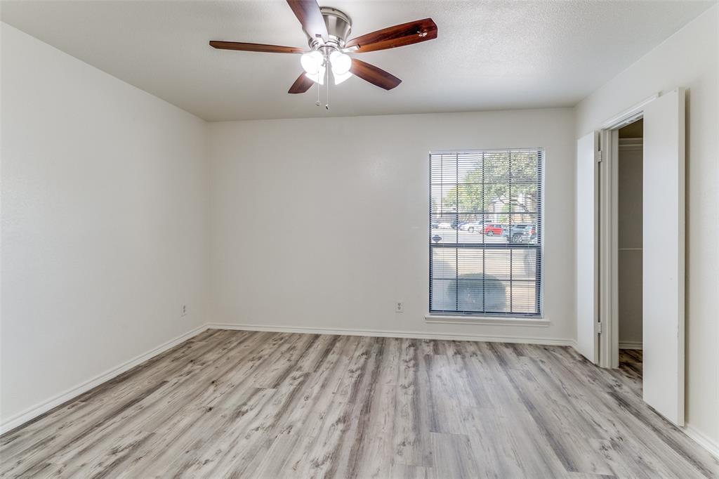 15151 Berry Trail, Unit 407 Dallas, TX 75248 - Photo 11 of 16 wooden floor in an empty room with a window