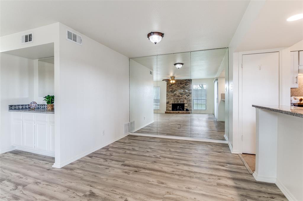 15151 Berry Trail, Unit 407 Dallas, TX 75248 - Photo 3 of 16 a view of empty room with wooden floor