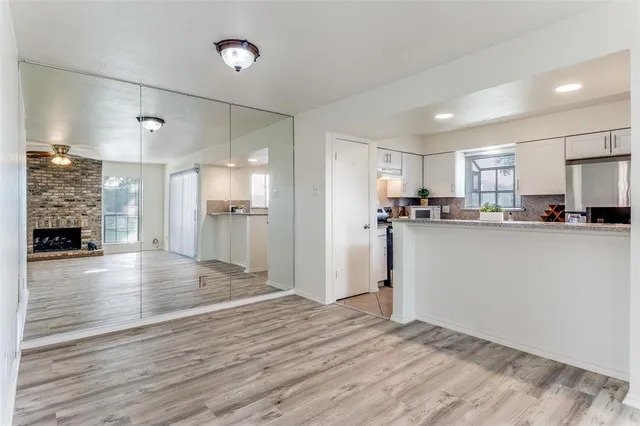 a view of a kitchen with a sink and a refrigerator