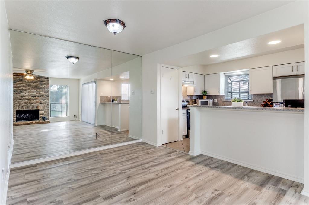 15151 Berry Trail, Unit 407 Dallas, TX 75248 - Photo 7 of 16 a view of a kitchen with a sink and a refrigerator