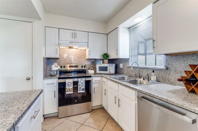 a kitchen with a sink stove and cabinets