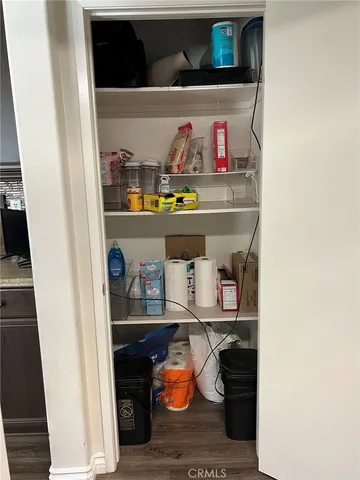a view of a workspace with furniture and a potted plant