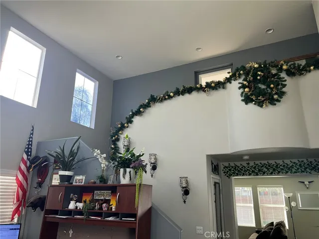 a spacious bedroom with a bed and ceiling fan