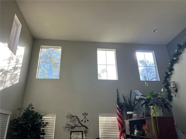 a spacious bedroom with a bed and a large mirror