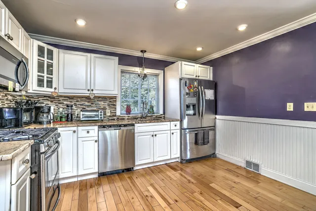 a kitchen with stainless steel appliances granite countertop a stove and a sink