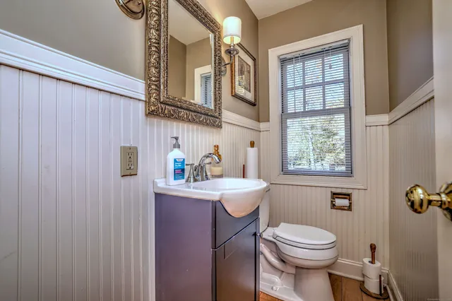 a bathroom with a toilet a sink and a window