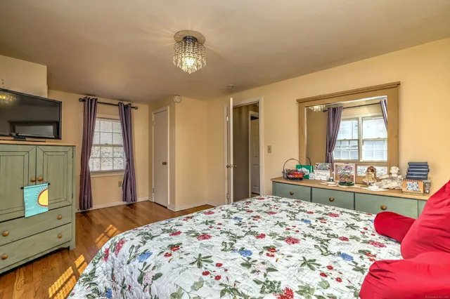 a bathroom with a granite countertop sink mirror vanity and toilet