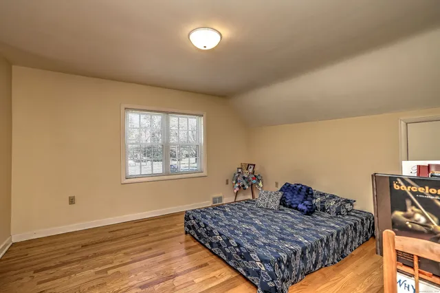 a bedroom with a bed and a book shelf