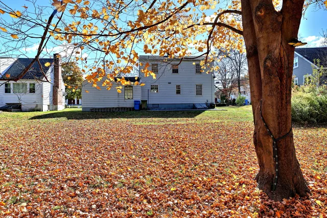 a front view of a house with a yard table and chairs
