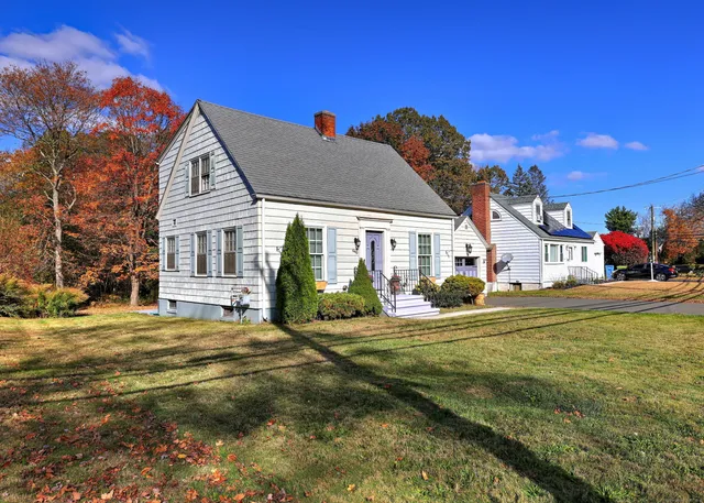 a view of a house with pool and chairs