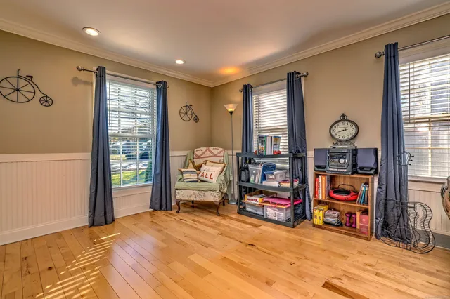 a view of a bedroom with furniture and window