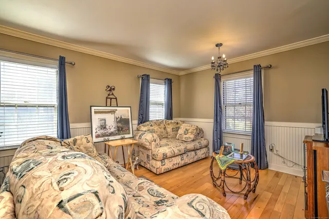 a bedroom with furniture and a large window