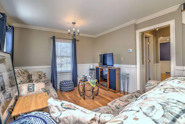 a bedroom with furniture and a chandelier