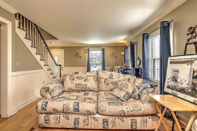 a view of a dining room with furniture and a chandelier