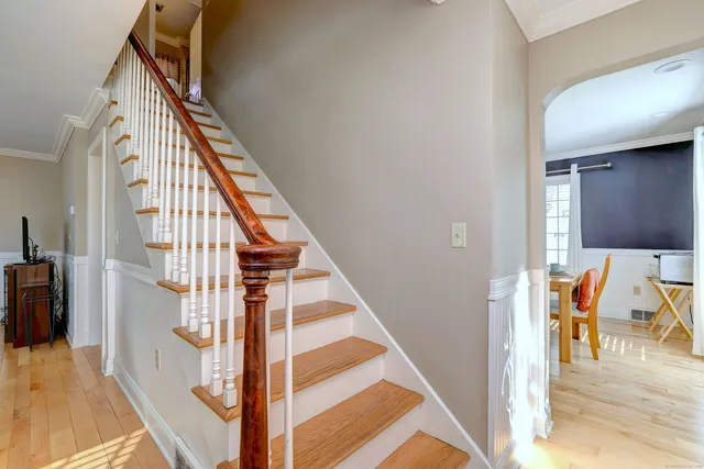 a view of entryway and hall with wooden floor