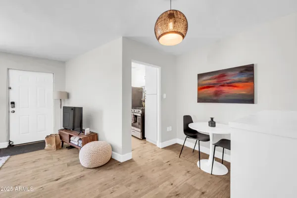 a living room with furniture and a painting on the wall