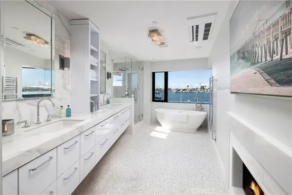 a bathroom with a toilet a sink a tub and mirror