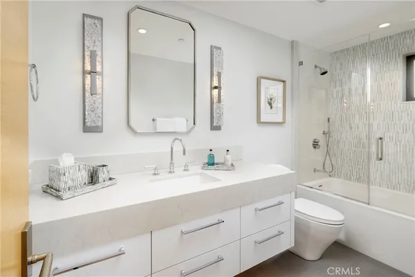 a patio with table and chairs potted plants and a palm tree