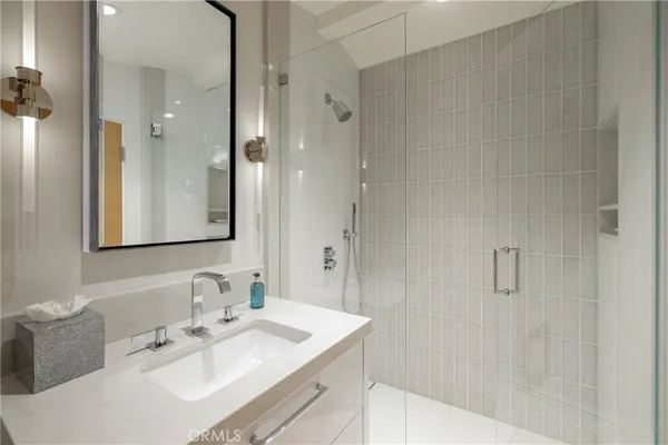 a living room with furniture a flat screen tv and floor to ceiling window