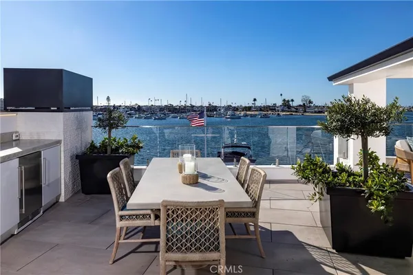 a view of a patio with couches table and potted plants