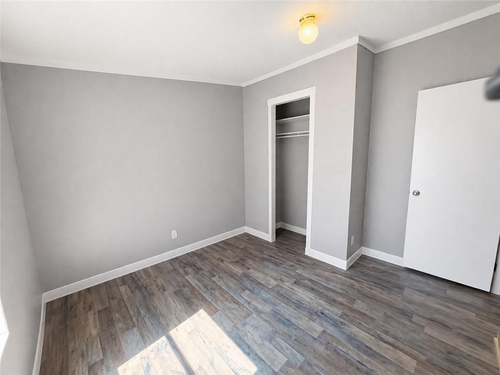 460 Cherokee Trail Ball Ground, GA 30107 - Photo 14 of 23 an empty room with wooden floor and windows