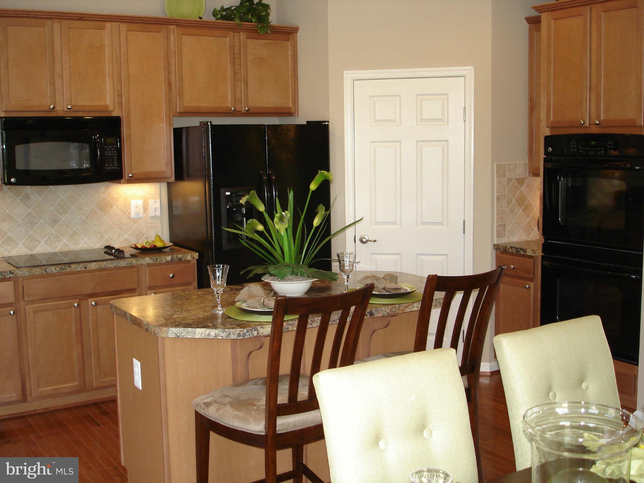 2414 Baileys Pond Road Accokeek, MD 20607 - Photo 4 of 22 a dining room with furniture a potted plant and a window