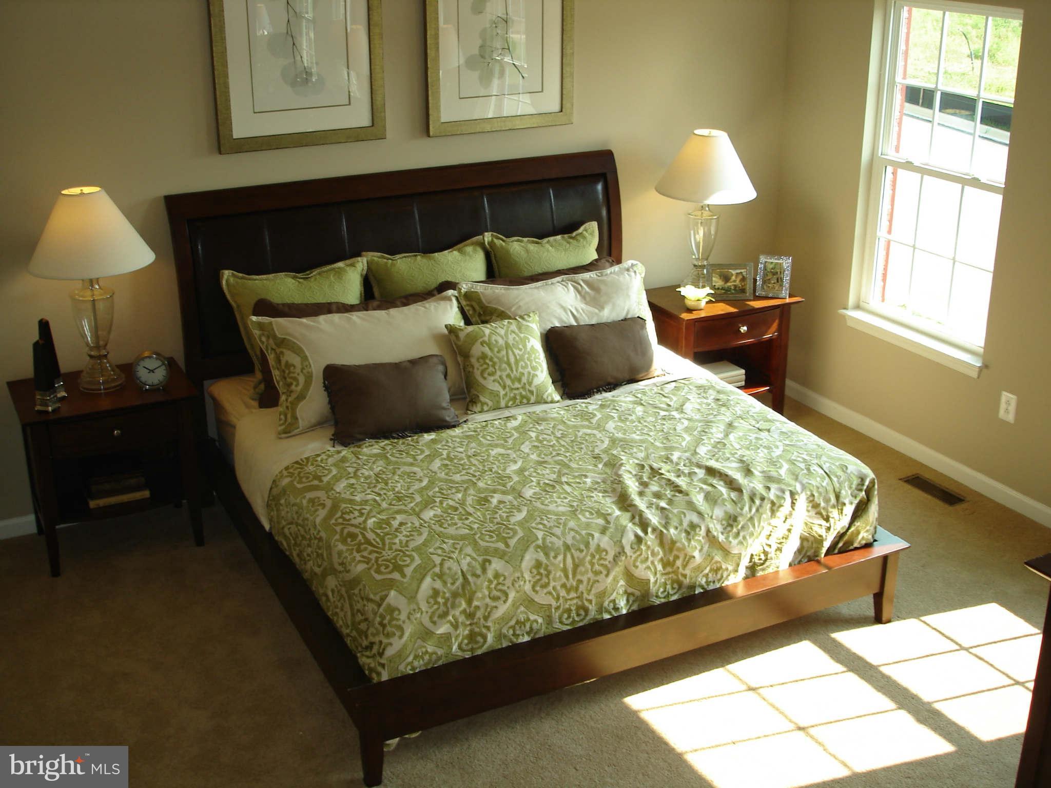2414 Baileys Pond Road Accokeek, MD 20607 - Photo 10 of 22 a bed sitting in a bedroom next to a window